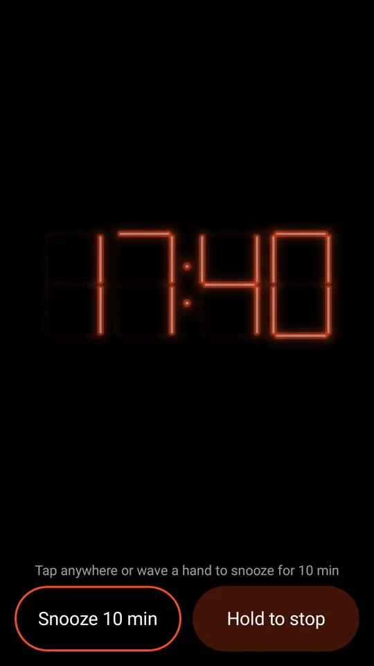 The alarm ringing: tap or wave to snooze, hold to stop